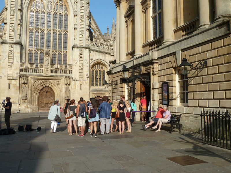 A group waits to go into the baths