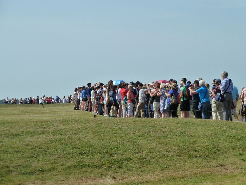 Crowds of people circle the stones