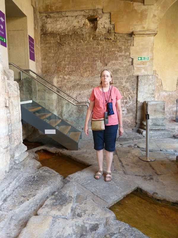 June stands on a stone bridge