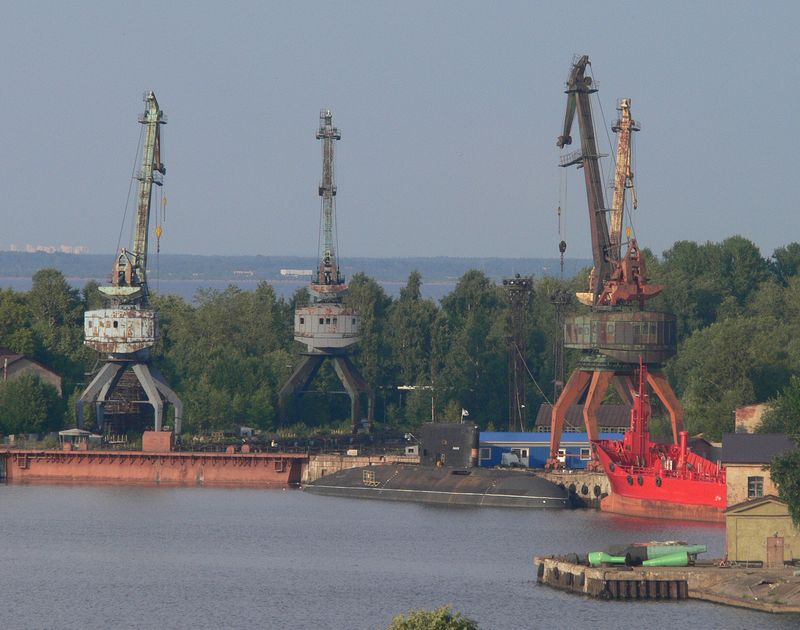 Rusty old cranes next to a submarine