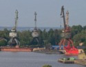 Rusty old cranes next to a submarine