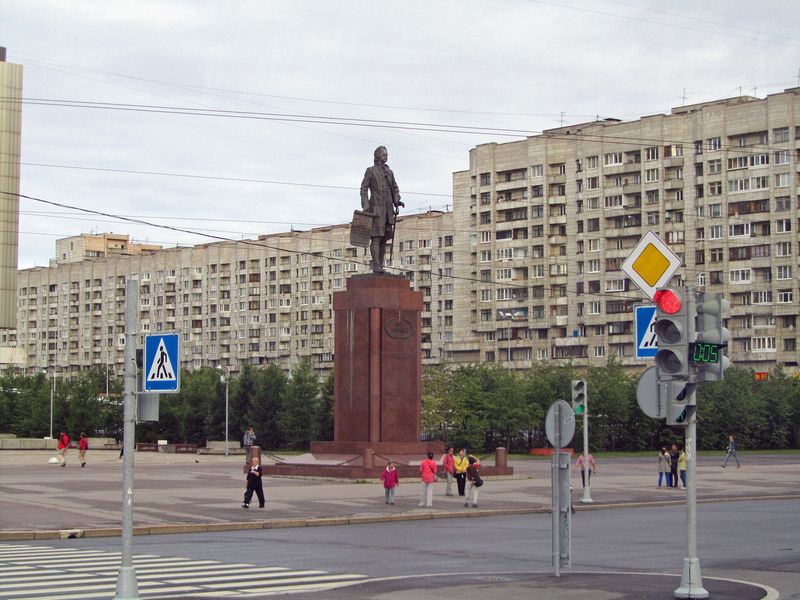 Statue of Peter the Great in front of Soviet era apartment buildings