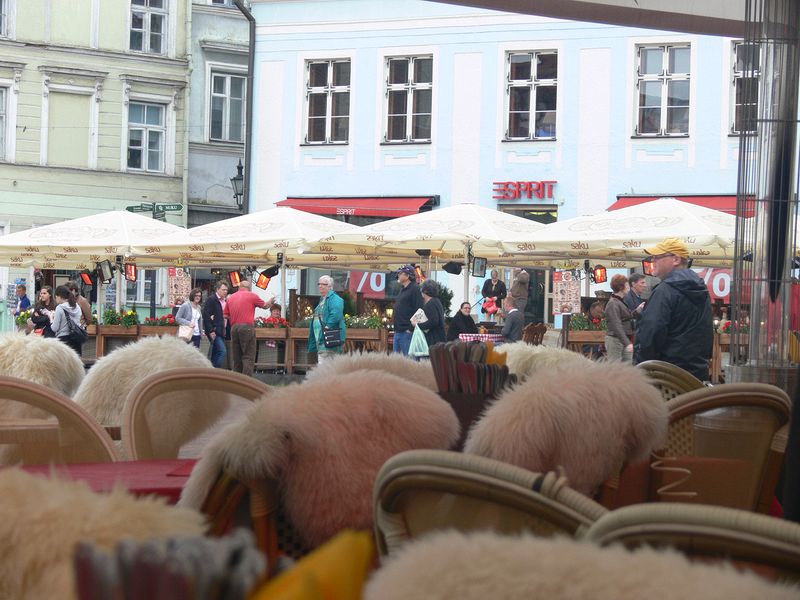 Fur-covered chairs at an open-air cafe