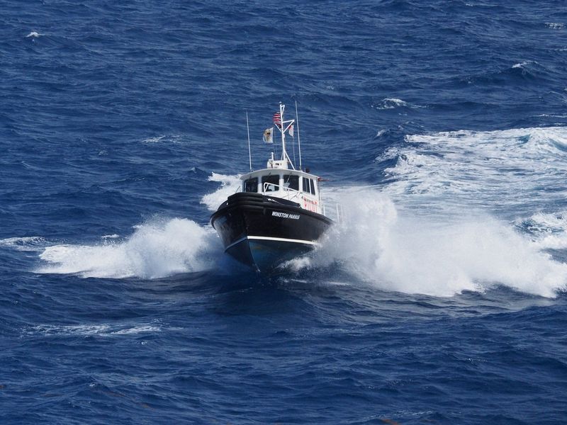 A pilot boat comes out to our ship