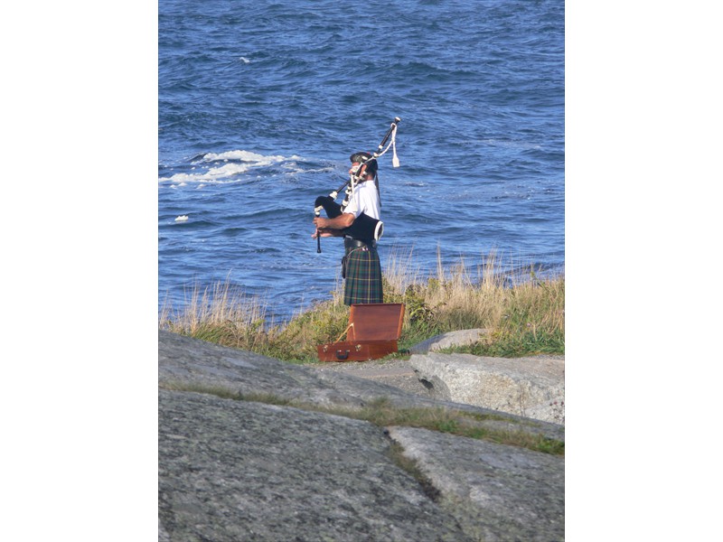 Bagpiper next to the ocean