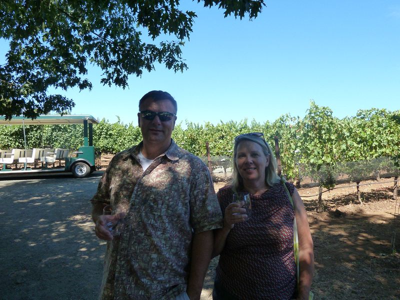 Brian and Diane sip in the vineyard