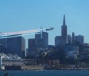 The Patriots fly by the city skyline