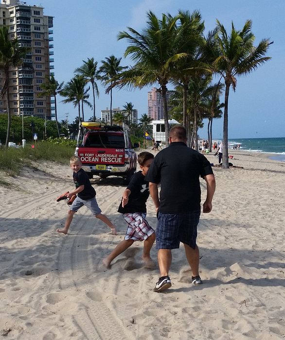 Dave plays tag on the beach with the boys