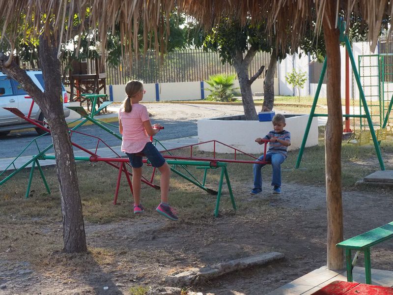 Cora and Grant on a teeter totter at the Salavation Army Orphanage