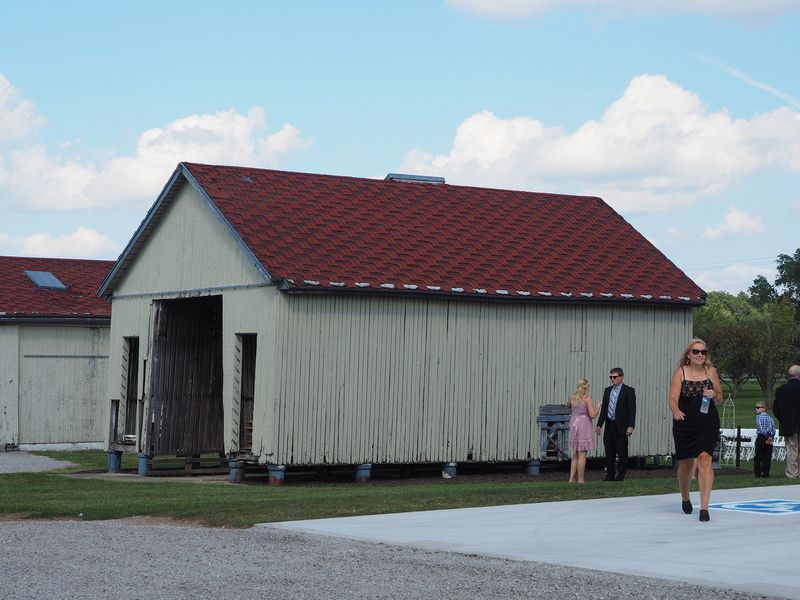 Theresa walks near outbuilding