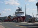 A big fishing boat is docked right downtown