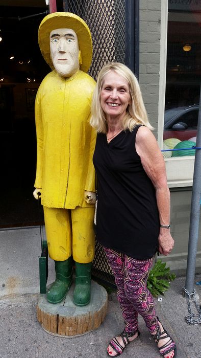 Eloise stands next to a statue