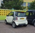 A Smart Car with a French license plate