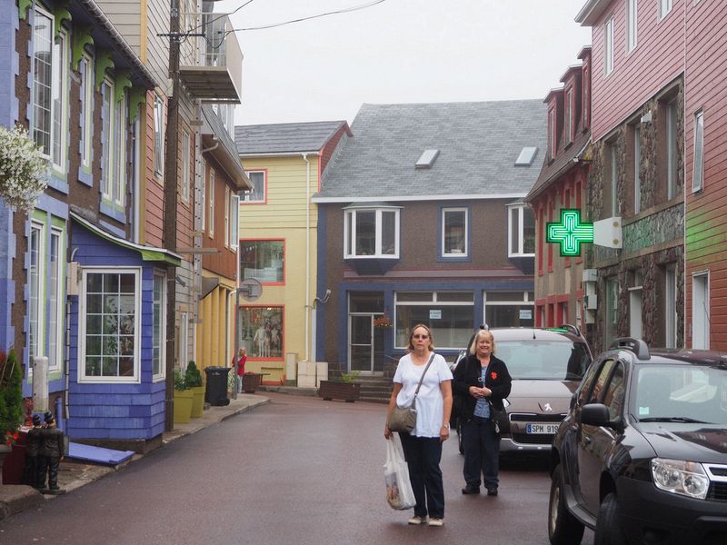 June and Linda next to colorful shops