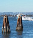 Ferry leaves past pilings