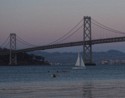 Kayaks and sailboat at dusk