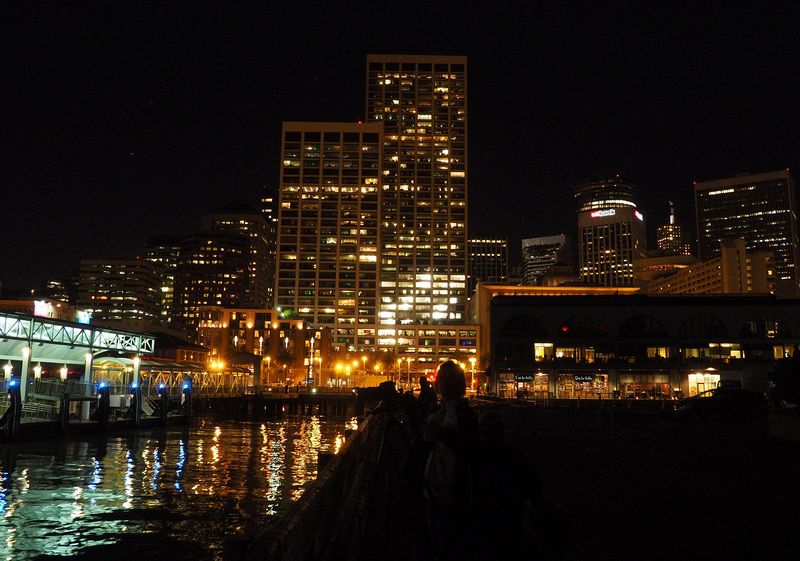 Lights from buildings reflect off the water