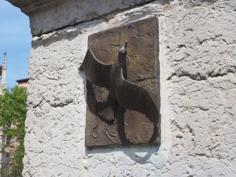 A bird sculpture on a bridge