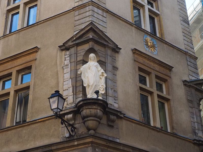 A statue of Mary on a street corner