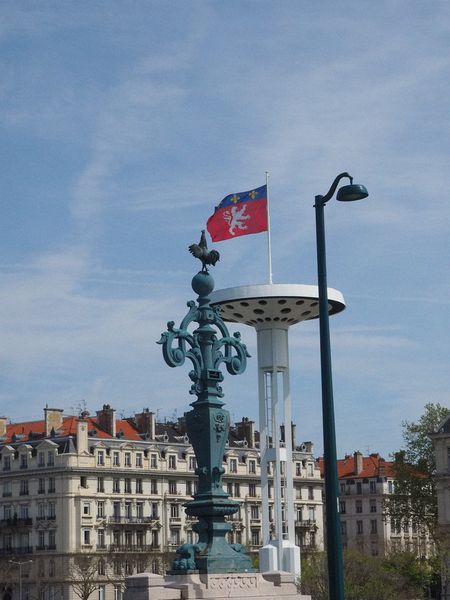 French rooster on pole and university lights