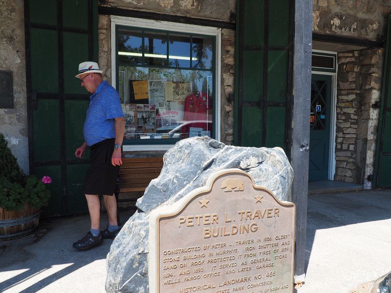 Livingston walks by the oldest stone building from 1856